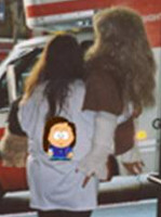 Lea viewed from the back; she's carrying Bubba toward a moving truck