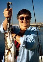 holding up a big fish she apparently just caught